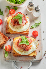 Homemade toast with egg, bacon and cherry tomato