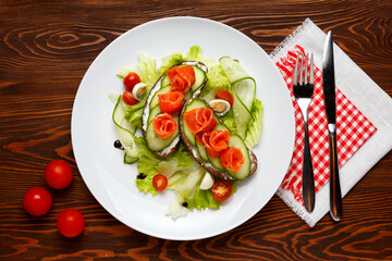 Norwegian Breakfast consisting of salmon and cucumber sandwiches, lettuce leaves and an egg