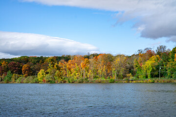 Hudson River in upstate New York in autumn colors. Vibrant colorful trees along the riverbank.