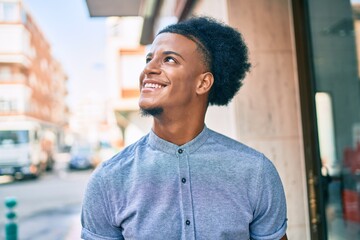 Young african american man smiling happy walking at the city.