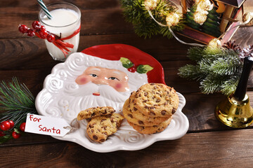 Obraz na płótnie Canvas glass of milk and cookies on wooden table for Santa Claus