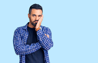 Fototapeta premium Young hispanic man wearing casual clothes thinking looking tired and bored with depression problems with crossed arms.