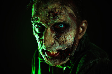 Scary zombie on dark background. Halloween monster