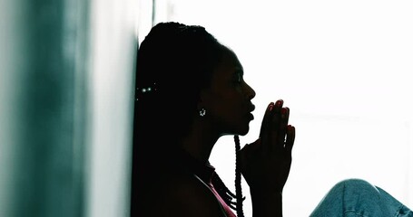 African woman praying with HOPE and FAITH - Powered by Adobe