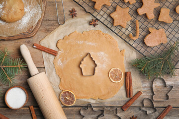 Making homemade Christmas cookies. Flat lay composition with dough and cutters on wooden background