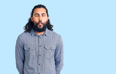 Young arab man wearing casual clothes making fish face with lips, crazy and comical gesture. funny expression.