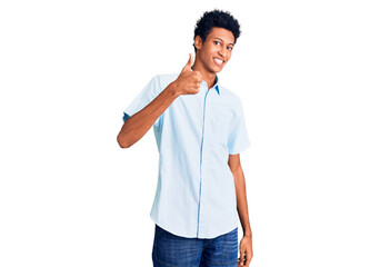 Young african american man wearing casual clothes doing happy thumbs up gesture with hand. approving expression looking at the camera showing success.