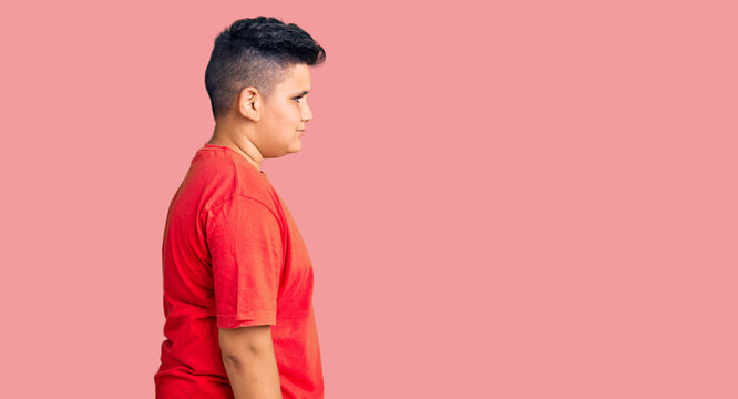 Little boy kid wearing casual clothes looking to side, relax profile pose with natural face with confident smile.