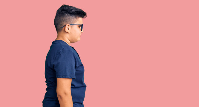 Little boy kid wearing casual clothes and glasses looking to side, relax profile pose with natural face with confident smile.