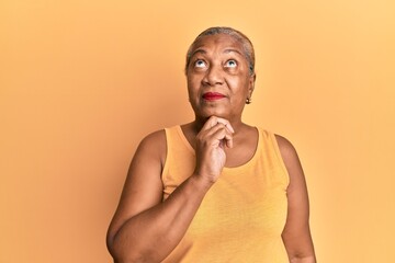 Senior african american woman wearing casual style with sleeveless shirt thinking concentrated...