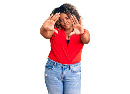Young african american plus size woman wearing casual style with sleeveless shirt doing frame using hands palms and fingers, camera perspective