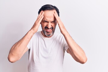 Middle age handsome man wearing casual t-shirt standing over isolated white background with hand on head, headache because stress. Suffering migraine.