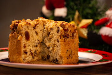Fruit panettone topped with chestnuts on a plate decorated for Christmas
