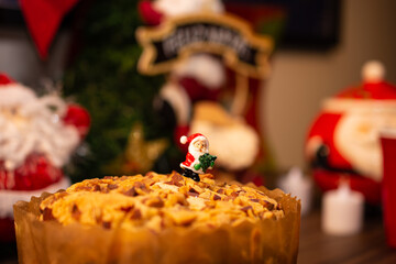Fruit panettone covered with chestnuts on a table decorated for Christmas. Selective focus.