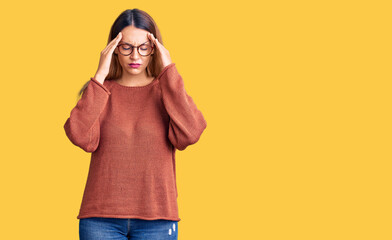 Beautiful young woman wearing casual clothes and glasses with hand on head for pain in head because stress. suffering migraine.