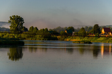 houses on the beach. Rural river in the early morning