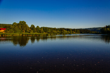 houses on the beach. Rural river in the early morning