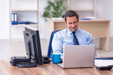 Young male employee unhappy with excessive work