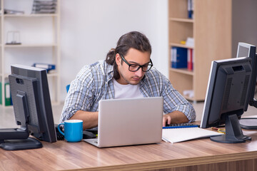 Young male it specialist working in the office