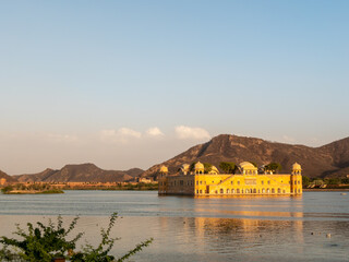 the historic jal mahal palace and lake man sagar at sunset in jaipur
