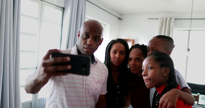 Black African family gathered together to take a selfie at home