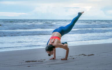 Team asian young healthy woman posing practice yoga on the beach at with blue cloud sky background in healthy exercise lifestyle concept