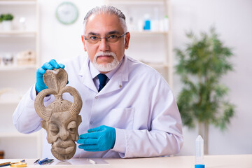 Senior archaeologist studying ancient african stonemask