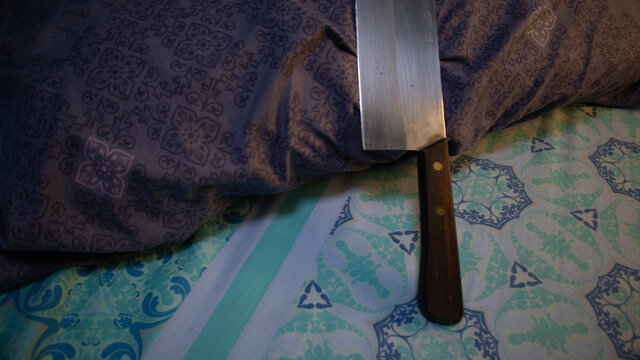 cleaver on the pillow, concept of family problems, aggession, prepareing, Self defense.