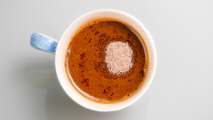 Top view Coffee in blue cup gray table with morning light. Warm tone.