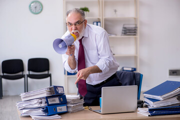 Aged male employee unhappy with excessive work