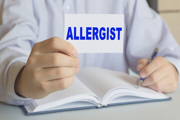 The doctor holds a card with the text . Medical concept