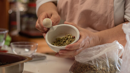 close up of a woman making a tea blend
