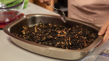 close up of a woman making a tea blend