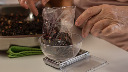close up of a woman making a tea blend