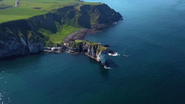 Aerial shot of Kinbane Castle in County Antrim, Northern Ireland, on a long, narrow limestone headland projecting into the sea