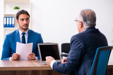 Young male candidate employee meeting with old recruiter