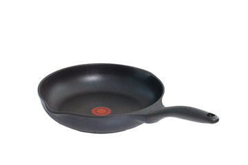 Black teflon skillet with non-stick coated surface and temperature indicator isolated on white background