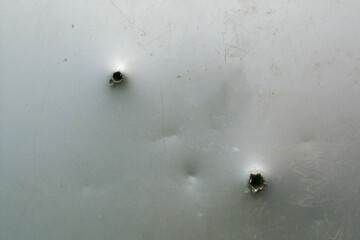 grunge metal background with ragged bullet holes