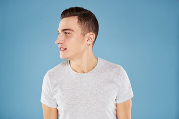 Fototapeta premium Emotional man in white t-shirt cropped view on blue background lifestyle