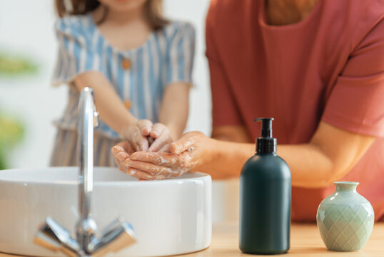 girl and her grandmother are washing hands