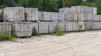 Packed with bandage tapes and stretch film bricks are stacked on wooden pallets in an abandoned warehouse