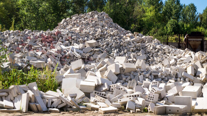 Pile of broken bricks and cracked silicate blocks