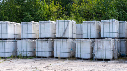 Packed with bandage tapes and stretch film bricks are stacked on wooden pallets in an abandoned warehouse