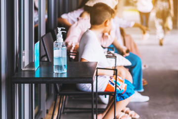 Blue alcohol gel bottle for hands cleaning to prevent the spreading of the Corona virus (Covid-19), Place the entrance service for customers  in the cafe. Healthcare concept. New normal lifestyle.