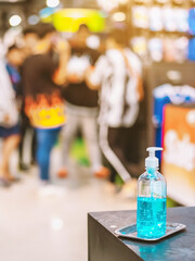 Blue alcohol gel bottle for hands cleaning to prevent the spreading of the Corona virus (Covid-19),Place the entrance service for customers  in the sport store.Healthcare concept.New normal lifestyle.