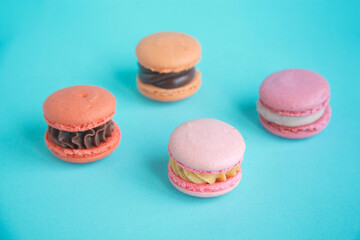 assortment colorful  korean macaroons on bright blue background