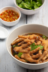 thai food ; Stewed Chicken Feet soup served with spicy fish sauce