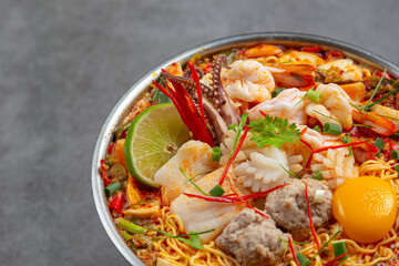 Thai food; instant noodles spicy boil with seafood and pork in hot pot