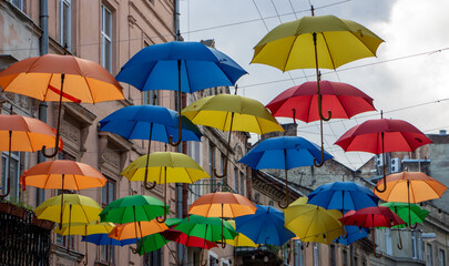 Multicolored umbrellas over the city street. Beautiful scenery.