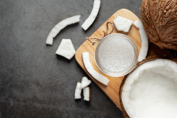 a glass of coconut water put on dark wooden background